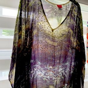 Dressy blouse with shiny rhinestones. Fits various sizes from 2 to 8